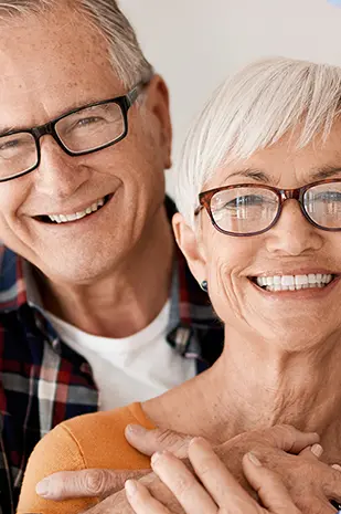 Un homme et une femme d’une soixantaine d’années souriants.